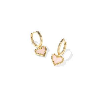 Gold hoop earrings with pink heart charms on a white background